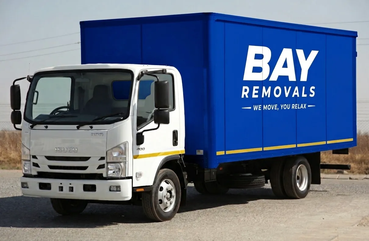 A Bay Removals closed truck with the BAY wordmark and tagline on its blue box body